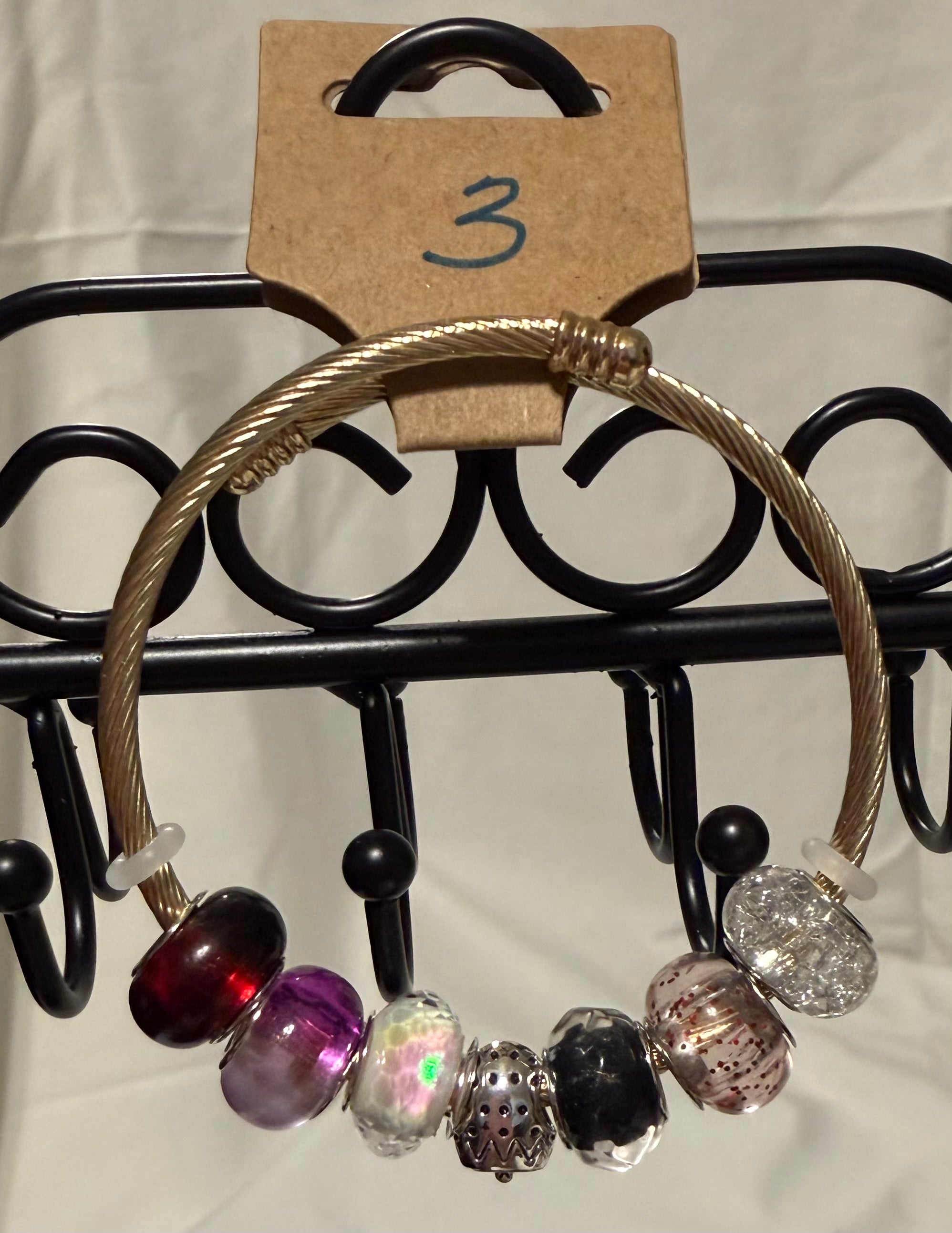 Gold toned wrap bracelet strawberry charm