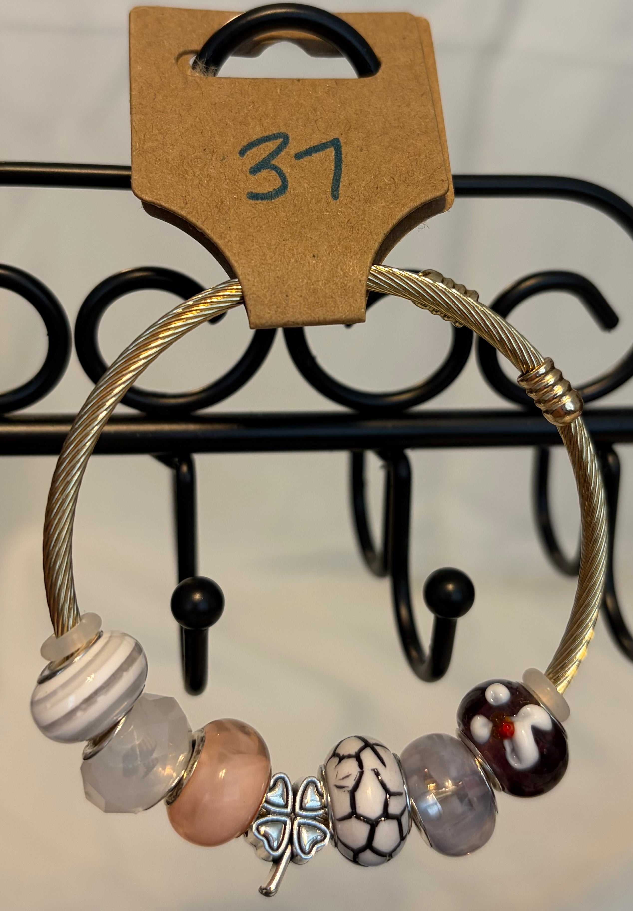 Gold toned wrap bracelet with clover charm