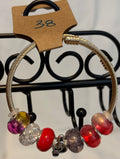 Gold toned wrap bracelet musical charm