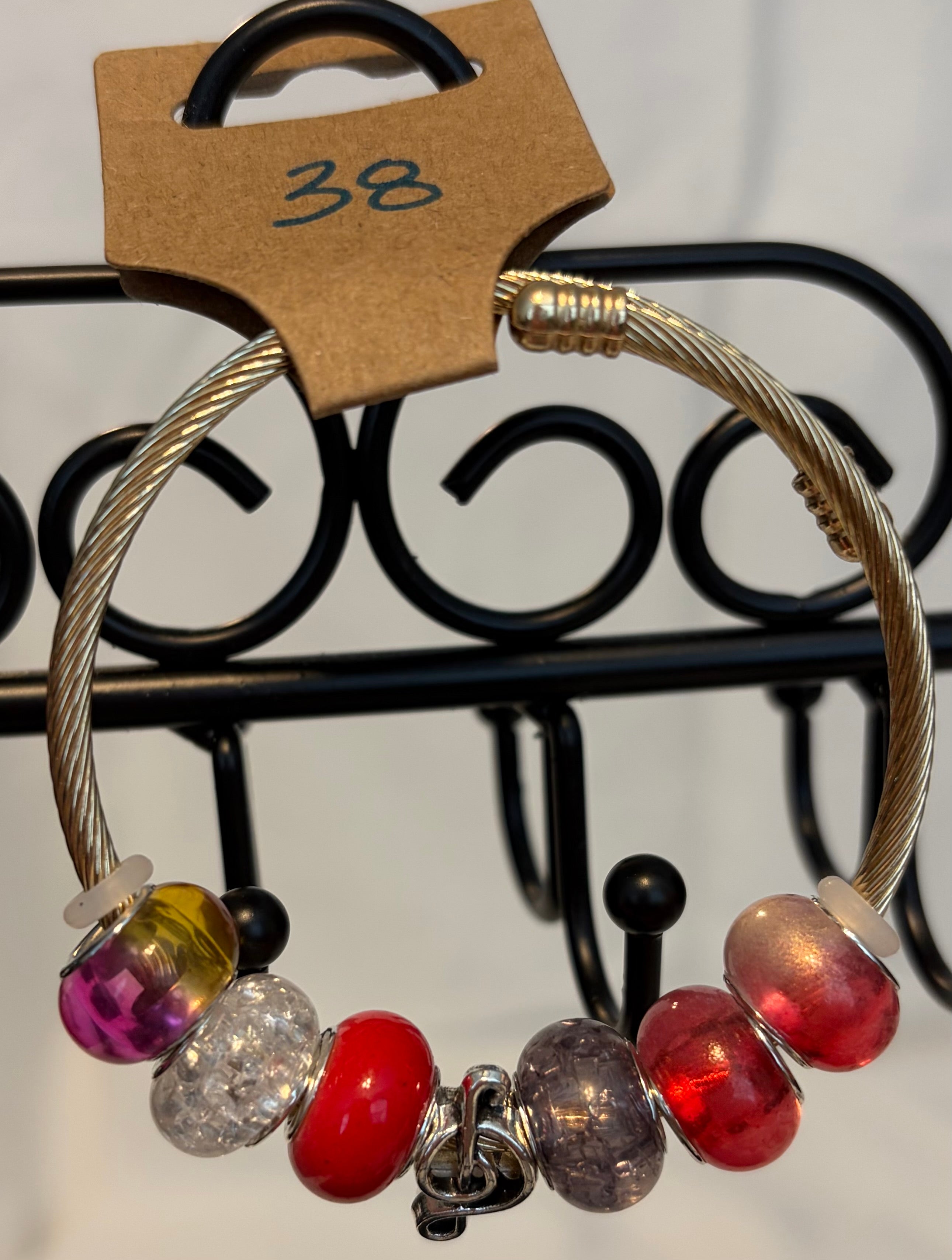 Gold toned wrap bracelet musical charm