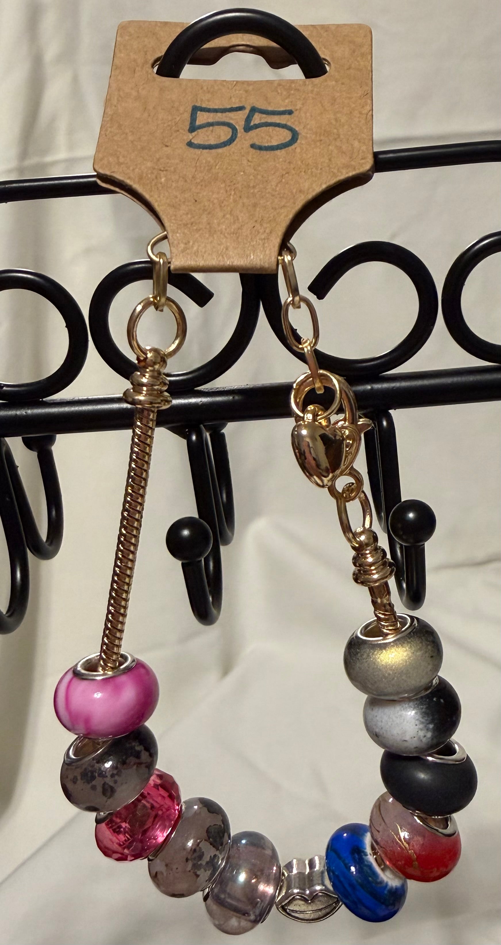 Gold toned bracelet with lip charm