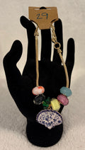 Gold toned adjustable bracelet with shell charm